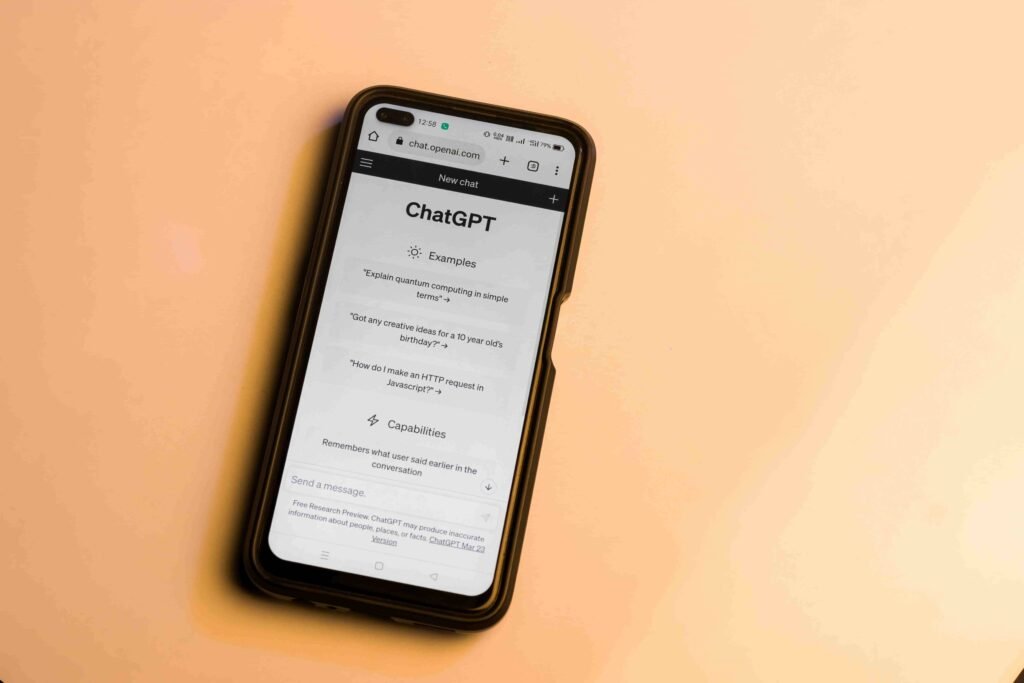 Webpage of chatgpt, a prototype ai chatbot, is seen on the website of openai, on a smartphone. Examples, capabilities, and limitations are shown.